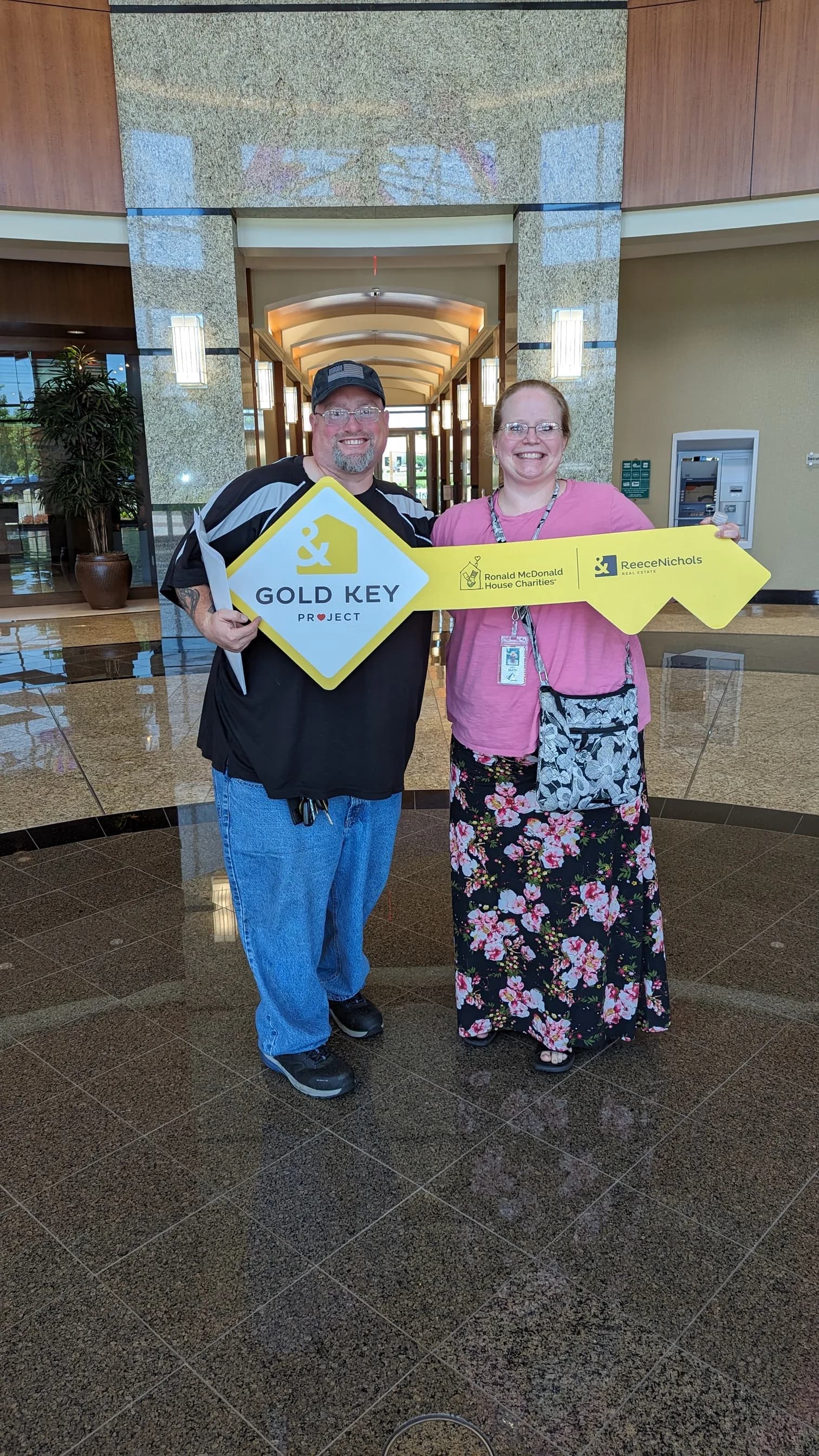 A group of clients holding the Gold Key sign