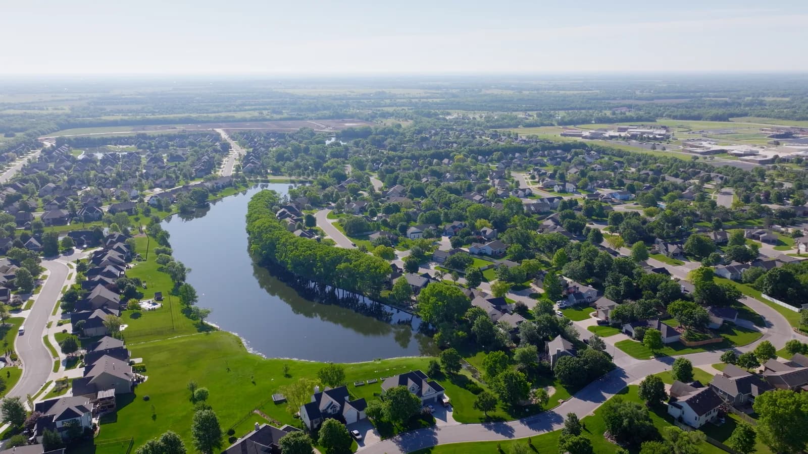 Aerial view of Andover homes built around a small lake