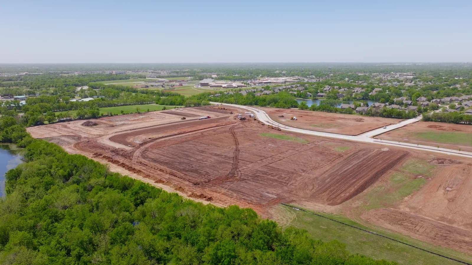 Aerial view of graded dirt and new roads at a development site in Andover