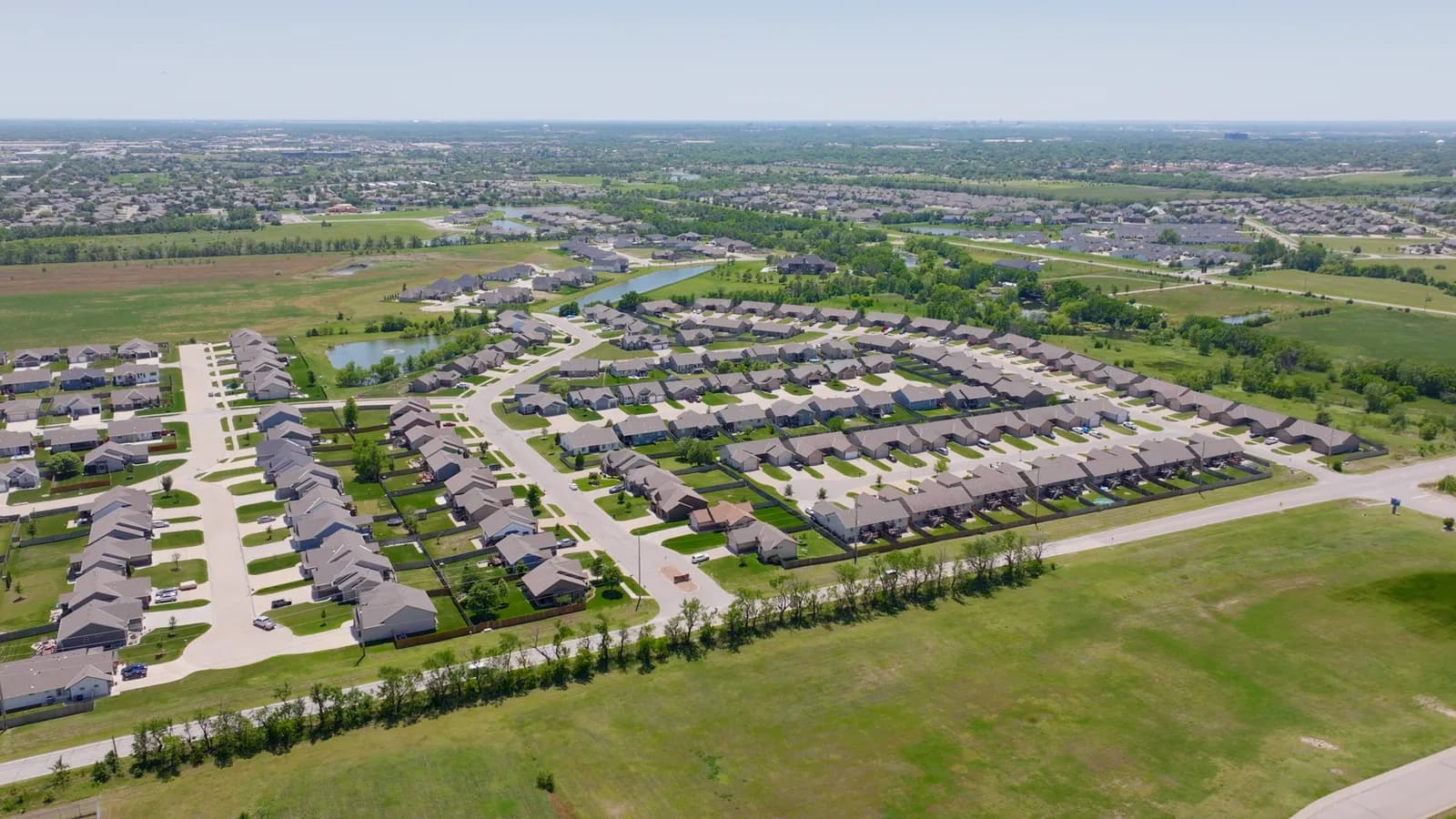 Aerial view of Bel Aire streets curving around a neighborhood pond