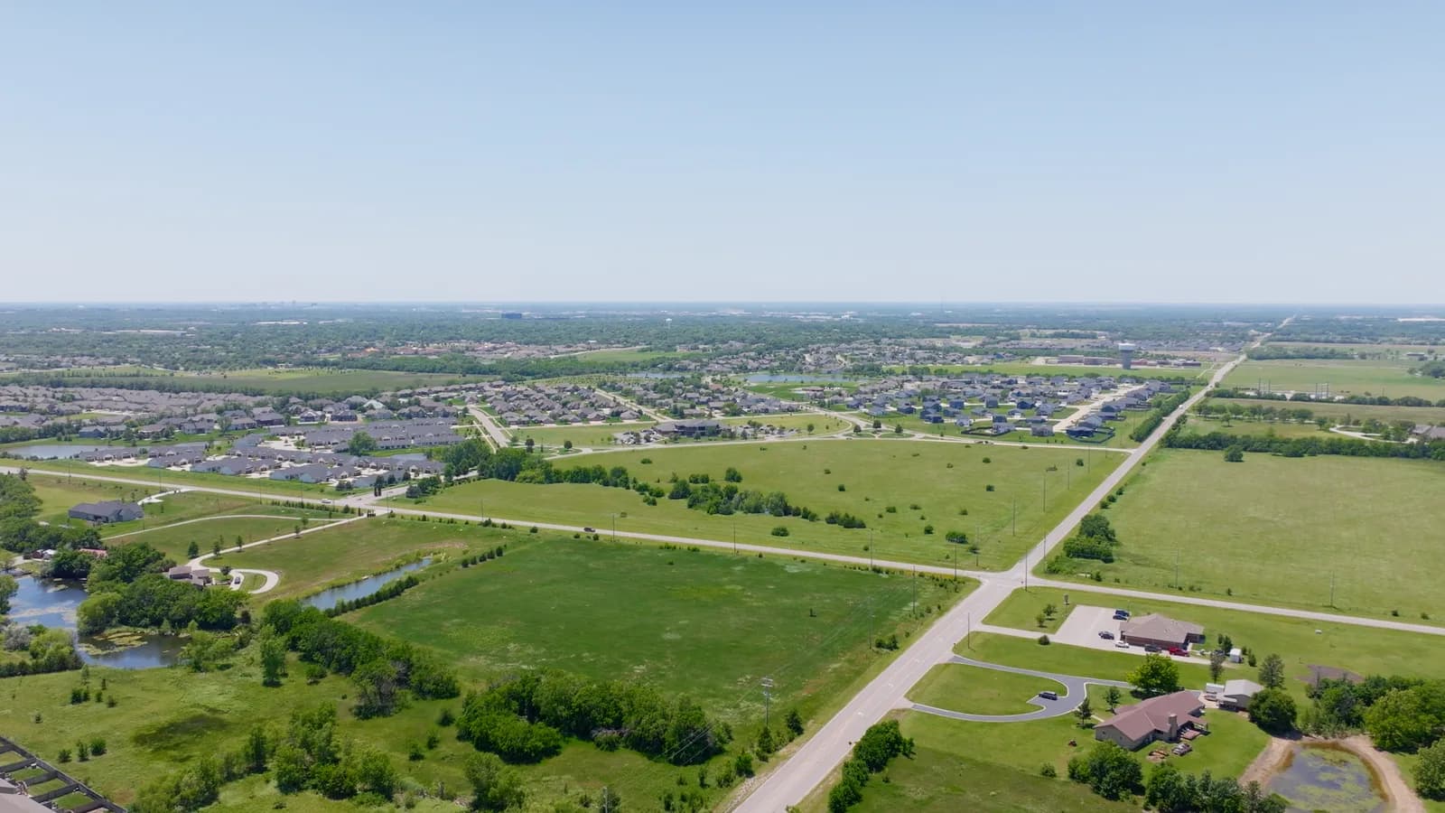Open grassland meeting neighborhoods on the edge of Bel Aire