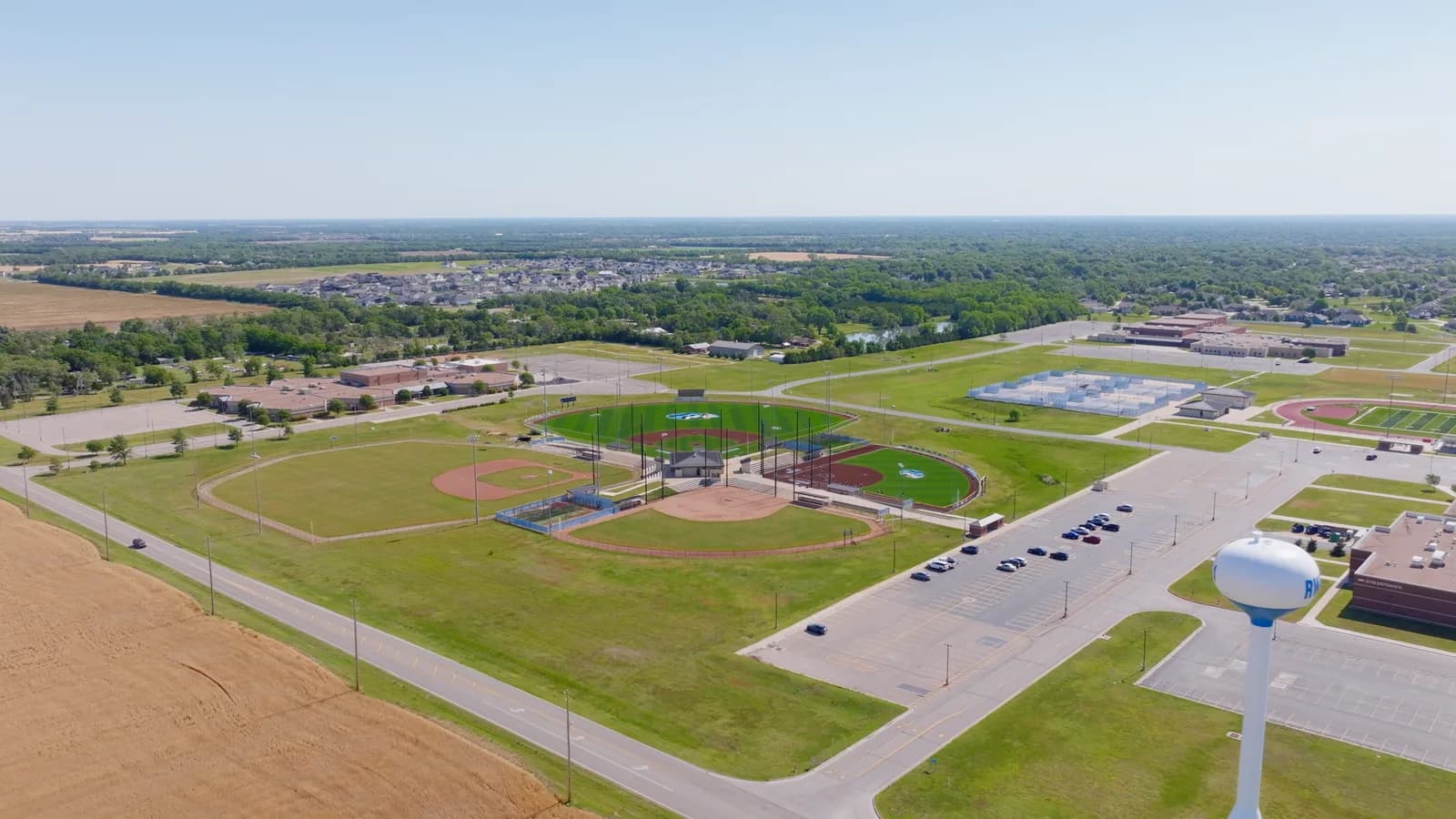 Ballfields and a playground beside a Goddard school campus