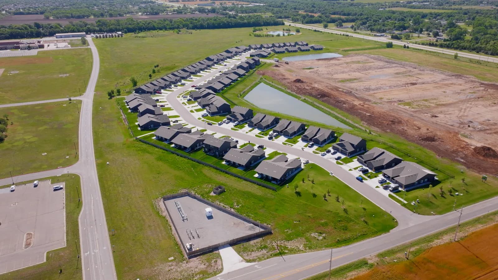 New homes beside freshly graded lots on the edge of Goddard
