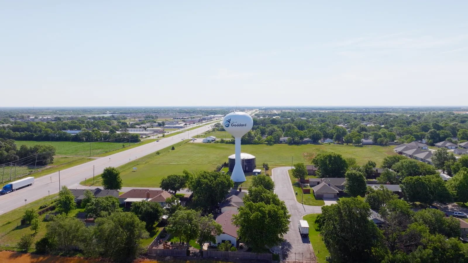 Goddard water tower rising over tree-lined streets