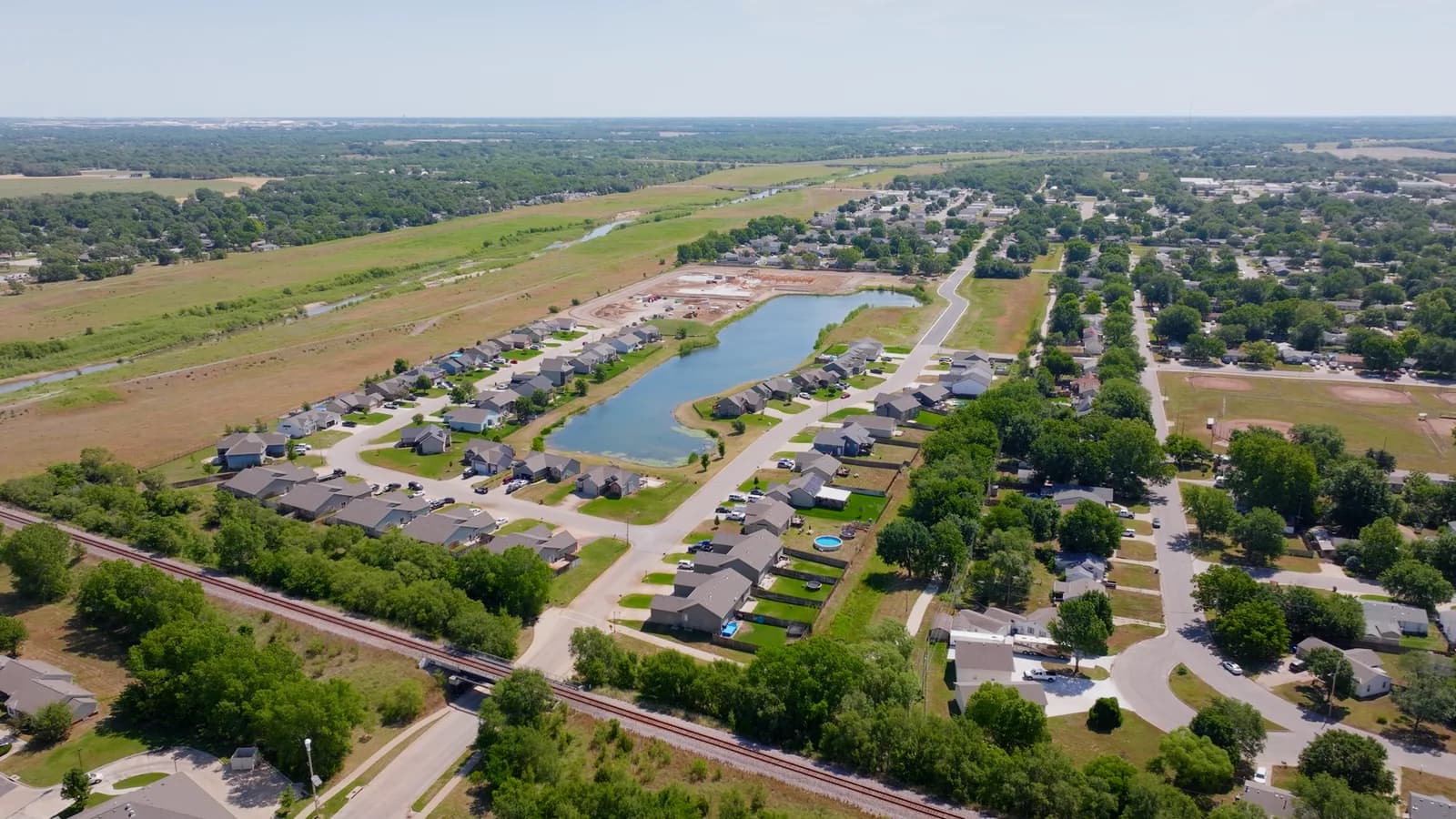 Aerial view of Haysville homes around a neighborhood pond