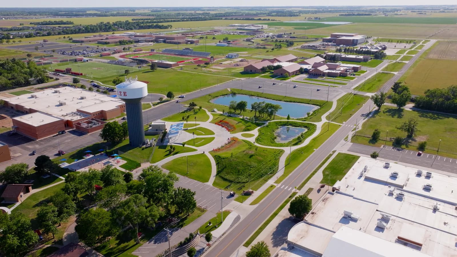 Wide aerial view of Maize with its water tower, schools, and green space