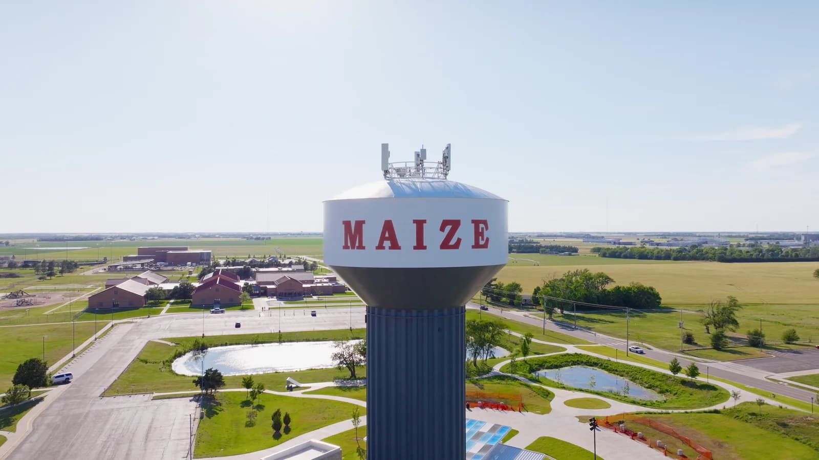 The Maize water tower with red lettering above the town