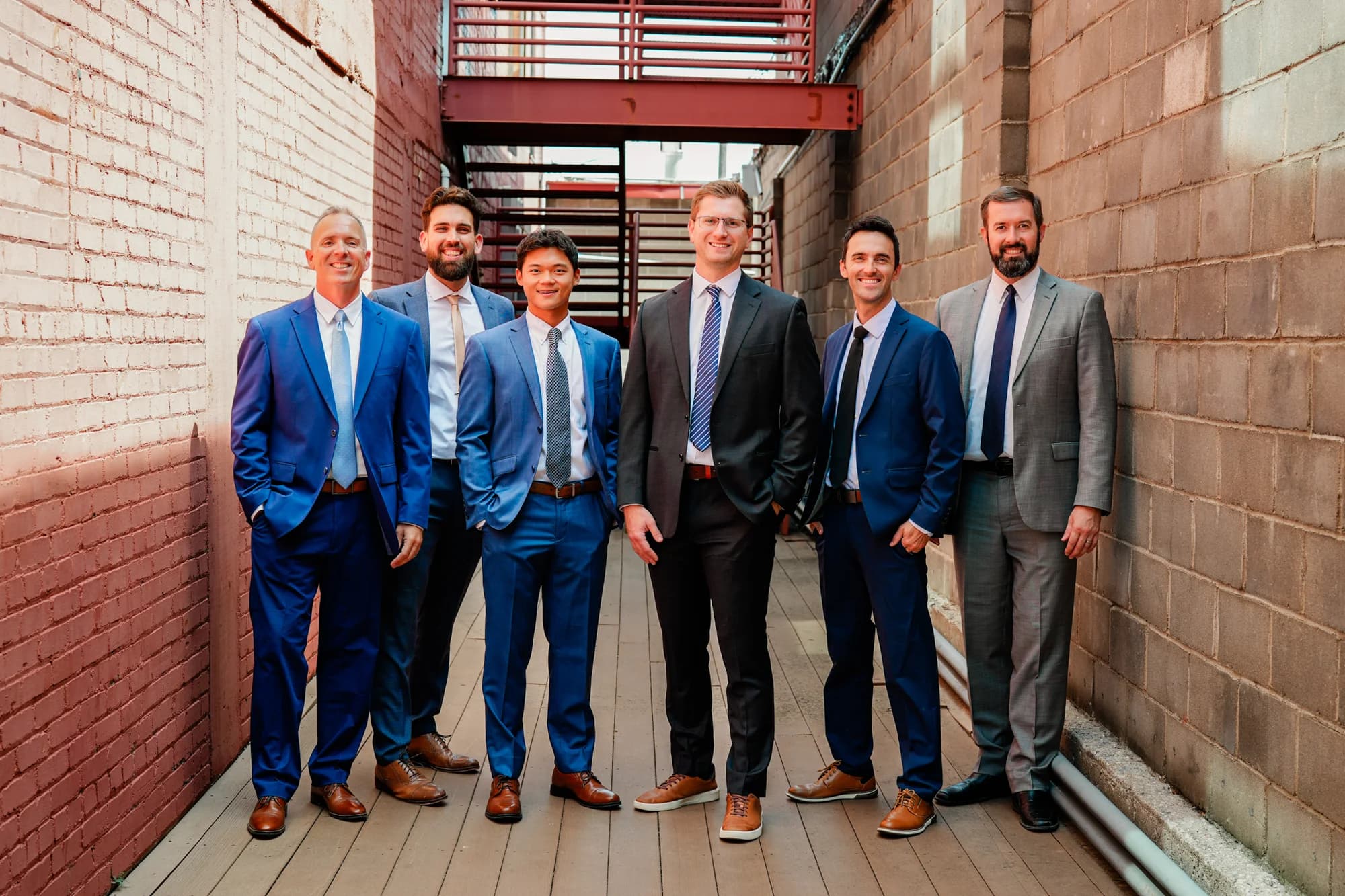 Caleb Claussen with his real estate team in an Old Town Wichita alley